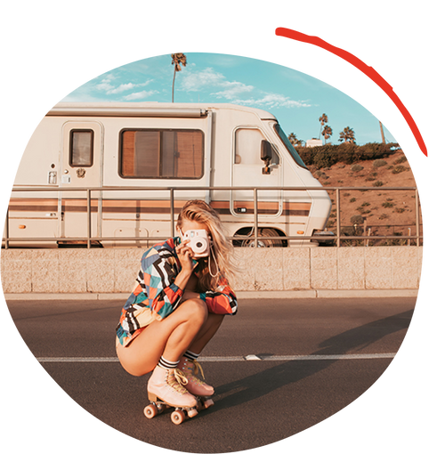 A woman in roller skates taking a photo