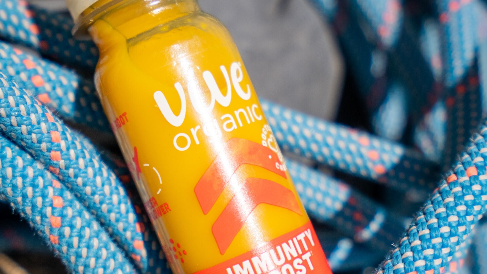 A Vive Organic Immunity Boost Original shot resting on a coiled climbing rope