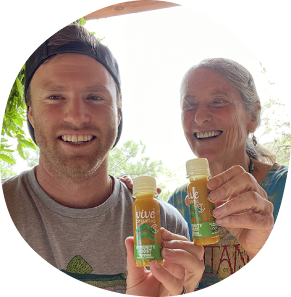 Wyatt Taubman with Dr. Erica Elliott smiling holding their immunity boost cayenne shots